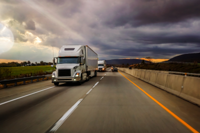 Two white truck wheelers on highway platooning